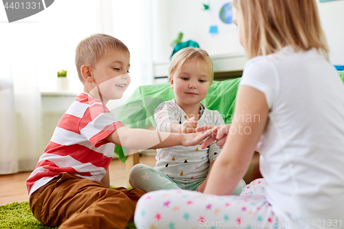 Image of kids playing rock-paper-scissors game at home