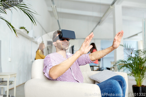 Image of happy man with virtual reality headset at office