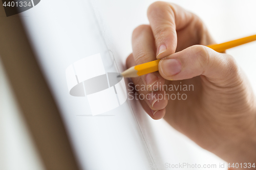 Image of artist with pencil drawing picture at art studio