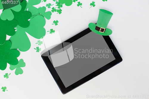 Image of tablet pc and st patricks day decorations on white