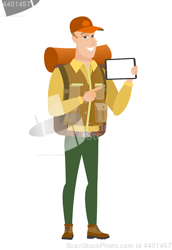 Image of Smiling traveler holding tablet computer.