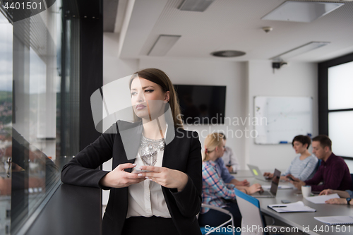 Image of Business Girl Standing In A Modern Building Near The Window With