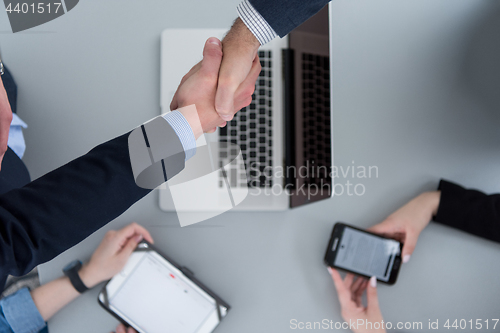 Image of cloasing the deal in modern office interior top view