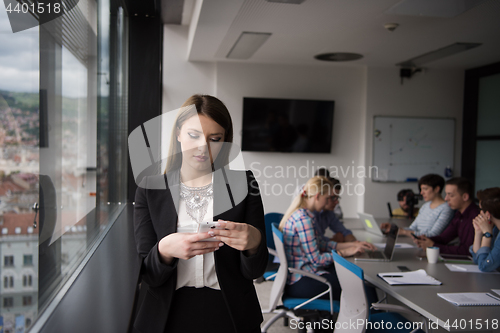 Image of Business Girl Standing In A Modern Building Near The Window With