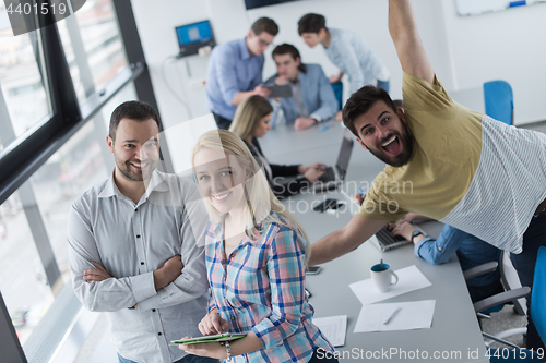 Image of Two Business People Working With Tablet in office