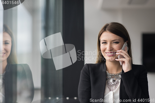 Image of Business Girl Standing In A Modern Building Near The Window With