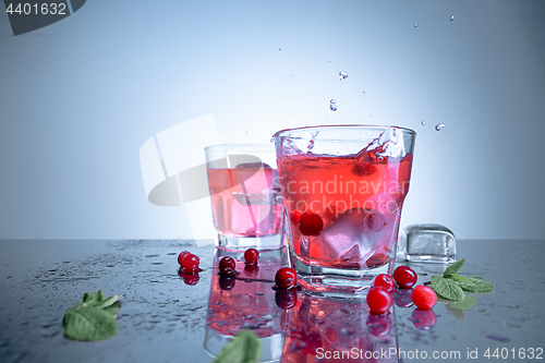 Image of closeup of a cape cod cocktail or vodka cranberry on a blue background