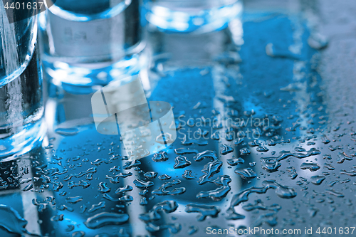 Image of Vodka glass with ice on blue background