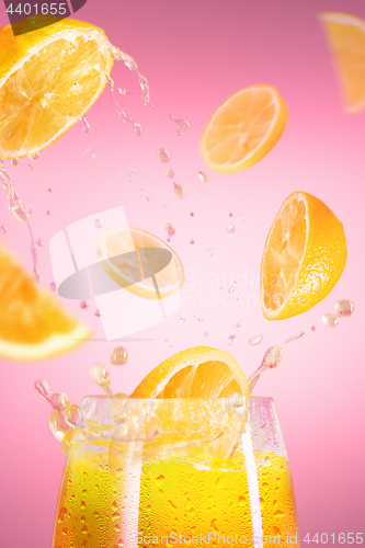 Image of Fresh lemons falling in juice with lot of huge splashes