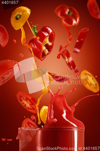 Image of Red tomato with pait splash on red background