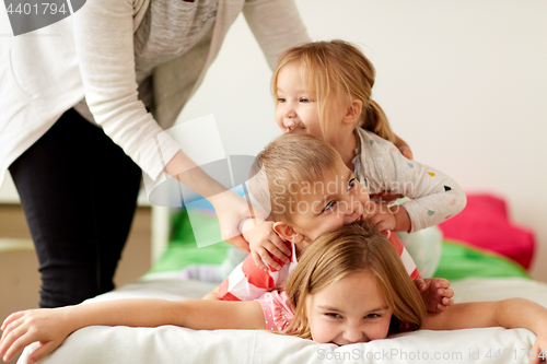 Image of mother and happy little kids having fun at home