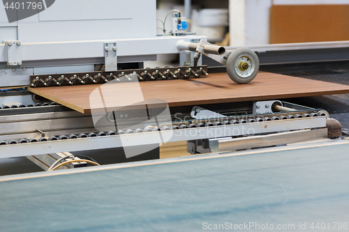 Image of chipboards on conveyer at furniture factory