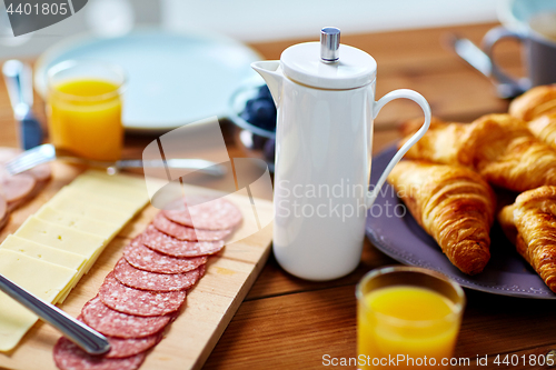 Image of coffee pot and food on served table at breakfast