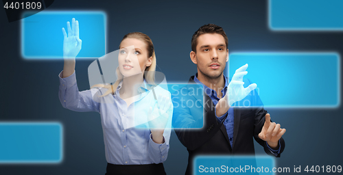 Image of businessman and businesswoman with virtual screens