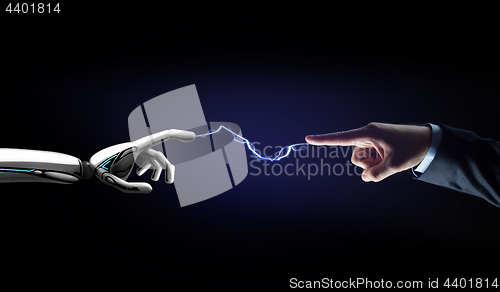 Image of robot and human hand connected by lightning