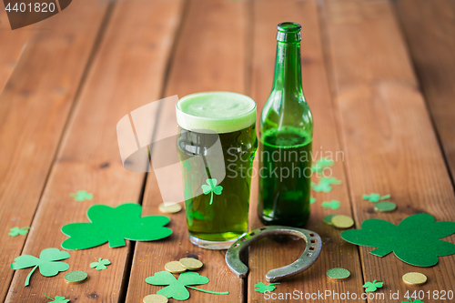 Image of glass of green beer, horseshoe and gold coins