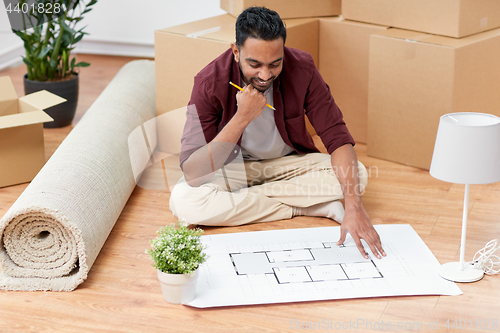 Image of man with boxes and blueprint moving to new home