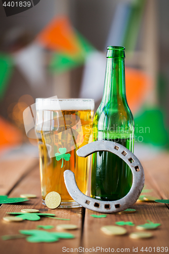 Image of glass of green beer, horseshoe and gold coins