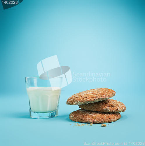 Image of Glass of milk and oatmeal cookies. Morning dessert