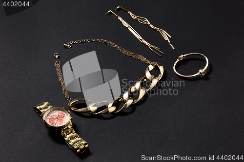Image of Woman accessories on black, side view