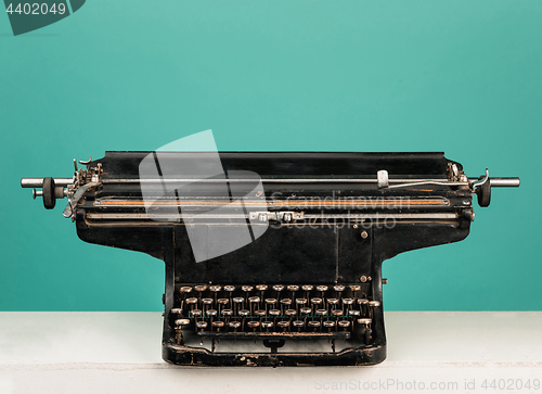 Image of Retro old typewriter with paper on wooden table
