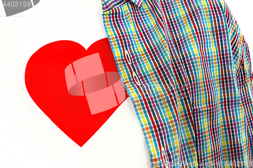 Image of Closeup of T-shirt with a red heart under colorful unbuttoned sh