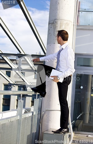 Image of handsome businessman with laptop computer on a building site