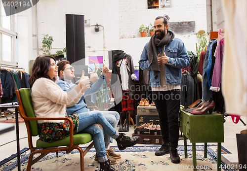 Image of friends choosing clothes at vintage clothing store