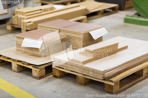 Image of wooden boards and chipboards storing at factory