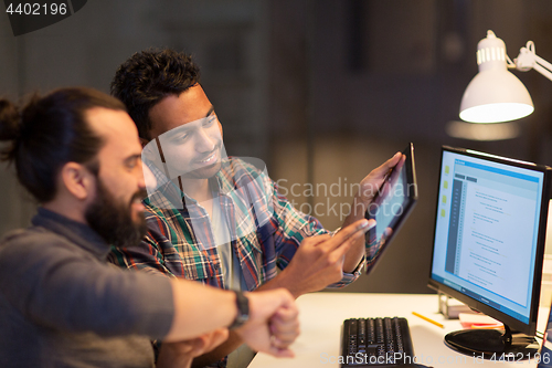 Image of creative team with tablet pc working at office