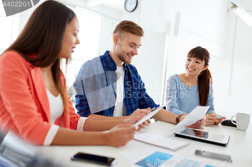 Image of happy creative team or students working at office