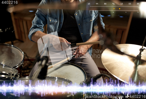 Image of drummer playing drum kit at sound recording studio