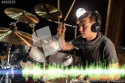 Image of musician playing drums at sound recording studio