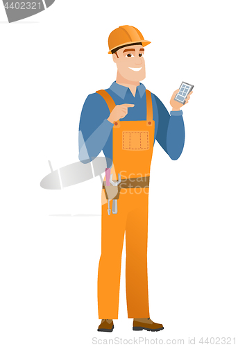 Image of Caucasian builder holding a mobile phone.