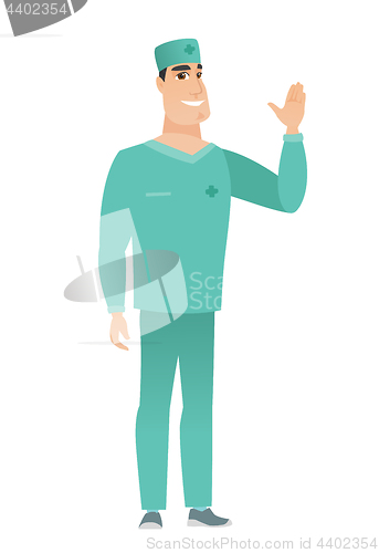 Image of Young caucasian doctor waving his hand.