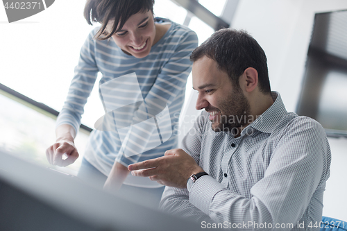 Image of Two Business People Working With Tablet in startup office