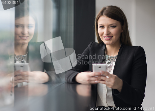 Image of Business Girl Standing In A Modern Building Near The Window With