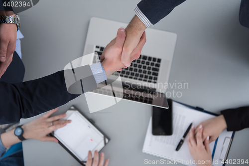 Image of cloasing the deal in modern office interior top view