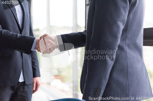 Image of cloasing the deal in modern office interior