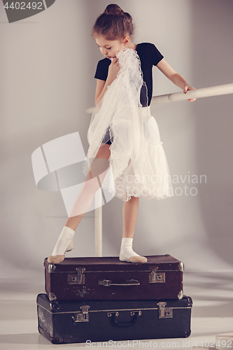 Image of The little girl as balerina dancer standing at studio