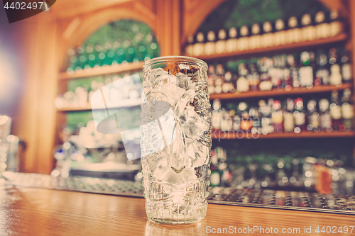 Image of Washed professional bar equipment and a glass filled with ice