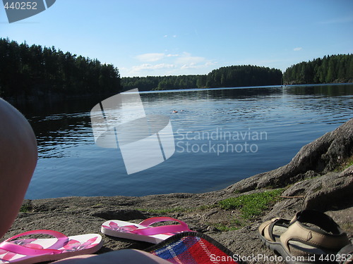 Image of Sunbathing by a small lake