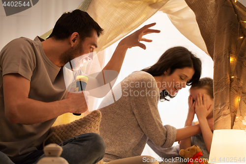 Image of father telling scary stories to his daughter