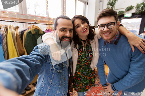 Image of friends taking selfie at vintage clothing store