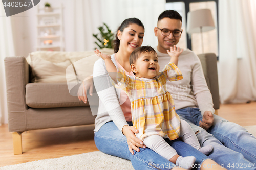 Image of happy family and baby daughter playing at home