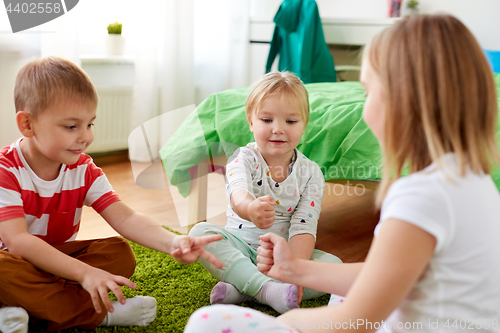 Image of kids playing rock-paper-scissors game at home