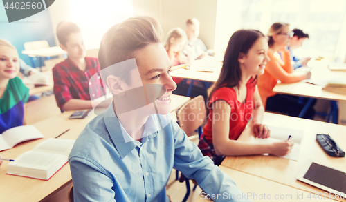 Image of group of students with notebooks at school lesson