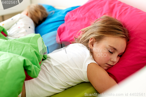 Image of little girls sleeping in bed at home