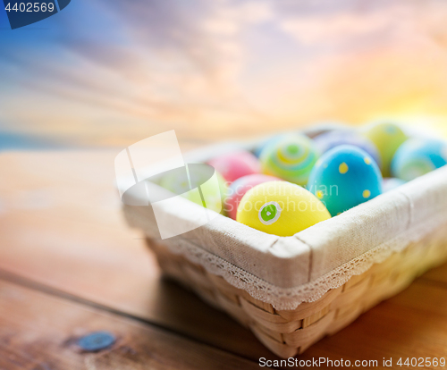 Image of close up of colored easter eggs in basket