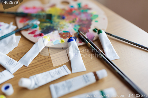 Image of palette, brushes and paint tubes on table